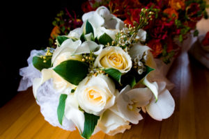 white bridal bouquet Urban Petals roses hosta wax flowers
